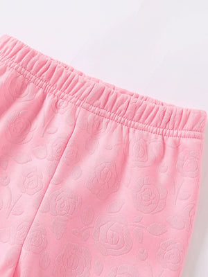 Pink baby leggings with embossed floral pattern and elastic waistband