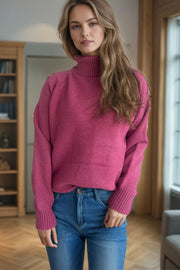Speckled Donegal turtleneck sweater in cerise with ribbed cuffs and neckline.