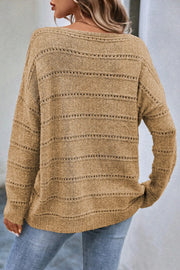 Tan openwork knit pullover sweater with boat neckline and long sleeves.