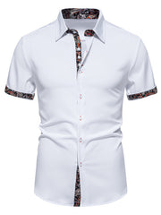 White short sleeve buttoned shirt with paisley trim on collar, cuffs, and placket.