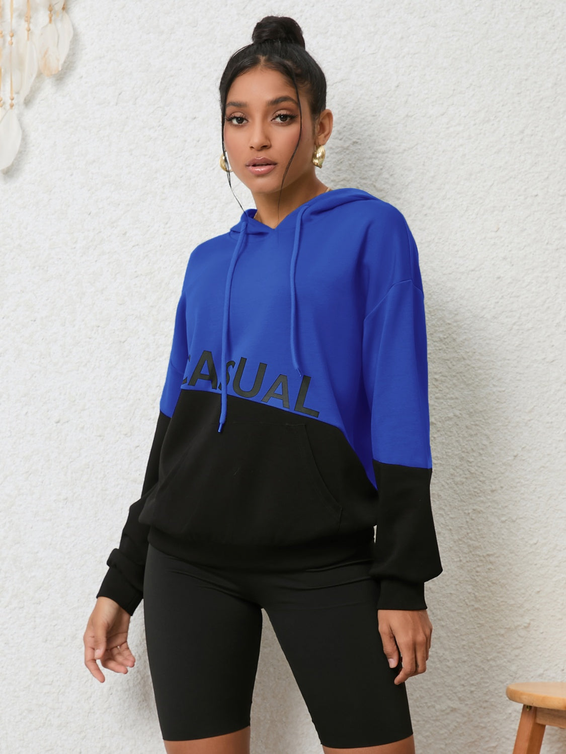 Royal blue and black colorblock hoodie with "CASUAL" graphic and front pocket.