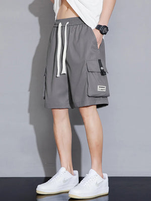 Grey cargo shorts with drawstring waist and multiple pockets, styled casually.