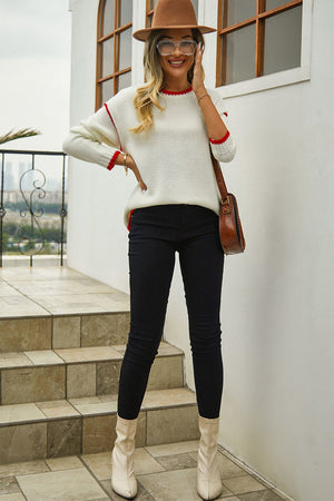 Cream acrylic crewneck sweater with contrast red trim on neckline and cuffs