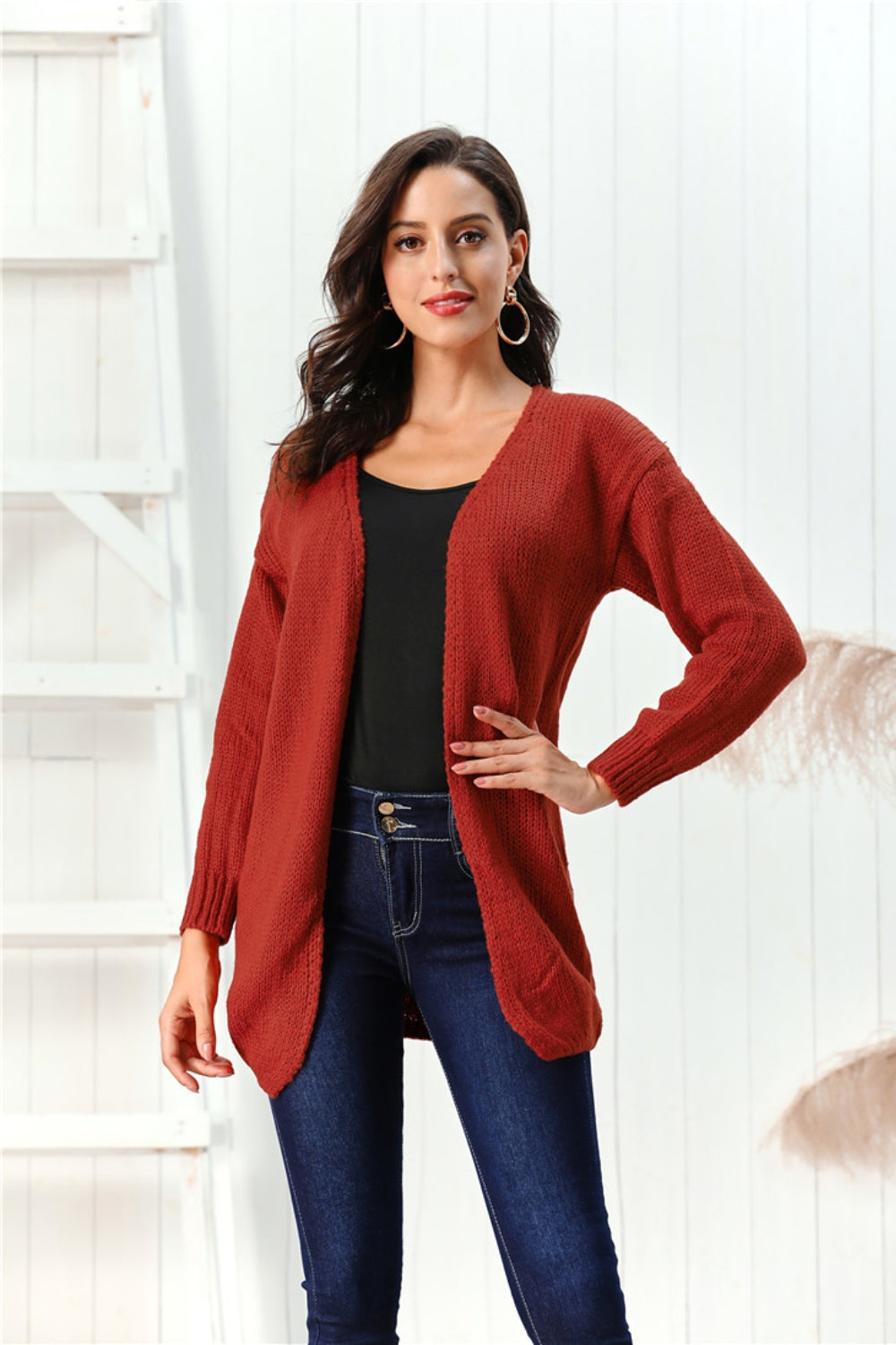 Draped knit open-front cardigan in deep red, 100% acrylic, with long sleeves and a relaxed fit.