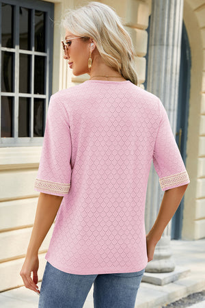 Blush pink textured V-neck top with lace trim on sleeves.