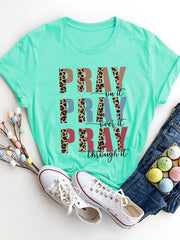 Aqua graphic t-shirt with "PRAY on it, PRAY over it, PRAY through it" text and leopard print accents.