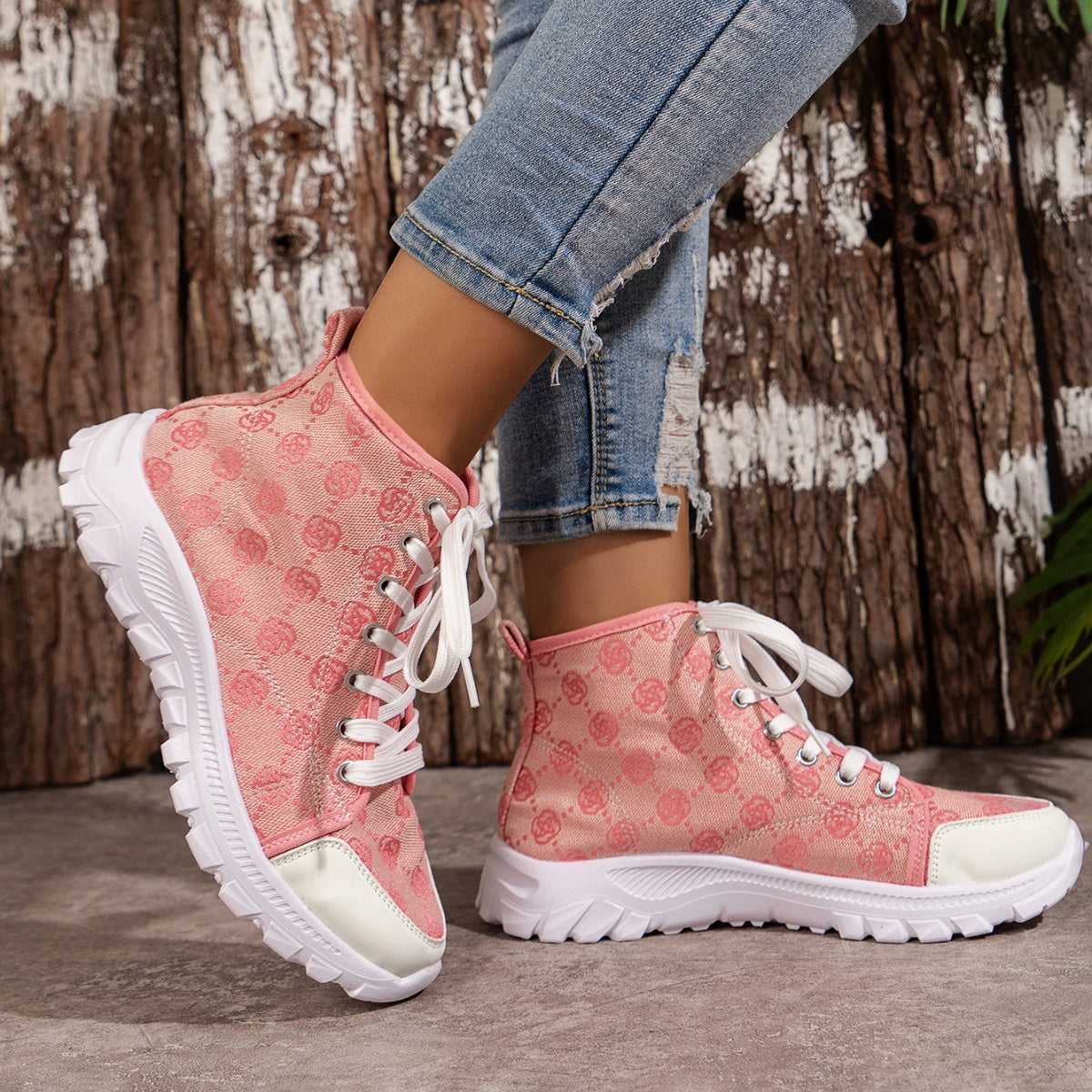 Pink lace-up high-top canvas sneakers with a subtle all-over pattern and white chunky sole.