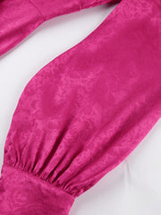Vibrant cerise mini dress with embossed floral pattern, deep V-neck, and lantern sleeves.