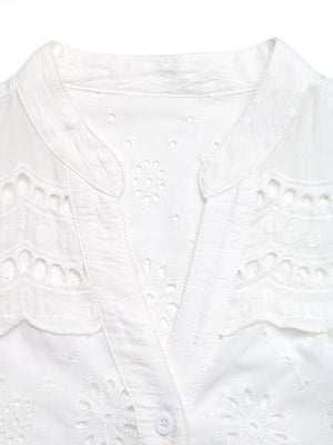 White eyelet embroidered button-up maternity shirt with V-neck and cutouts.