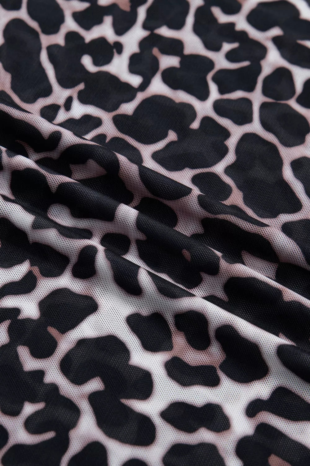 Leopard print sheer mesh t-shirt with a lightweight, see-through texture.