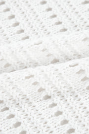 White open-knit dolman sleeve cardigan with a textured acrylic weave.