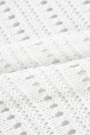 White open-knit dolman sleeve cardigan with a textured acrylic weave.
