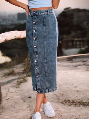 Button-front denim midi skirt in a medium blue wash with a slit hem.