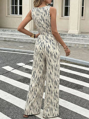 Chic tied waist wide-leg jumpsuit in abstract print with tie shoulders.