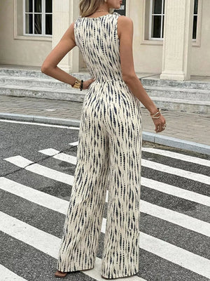 Chic tied waist wide-leg jumpsuit in abstract print with tie shoulders.