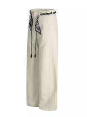 Cream white belted wide-leg maternity pants with black patterned scarf detail and beaded drawstrings.
