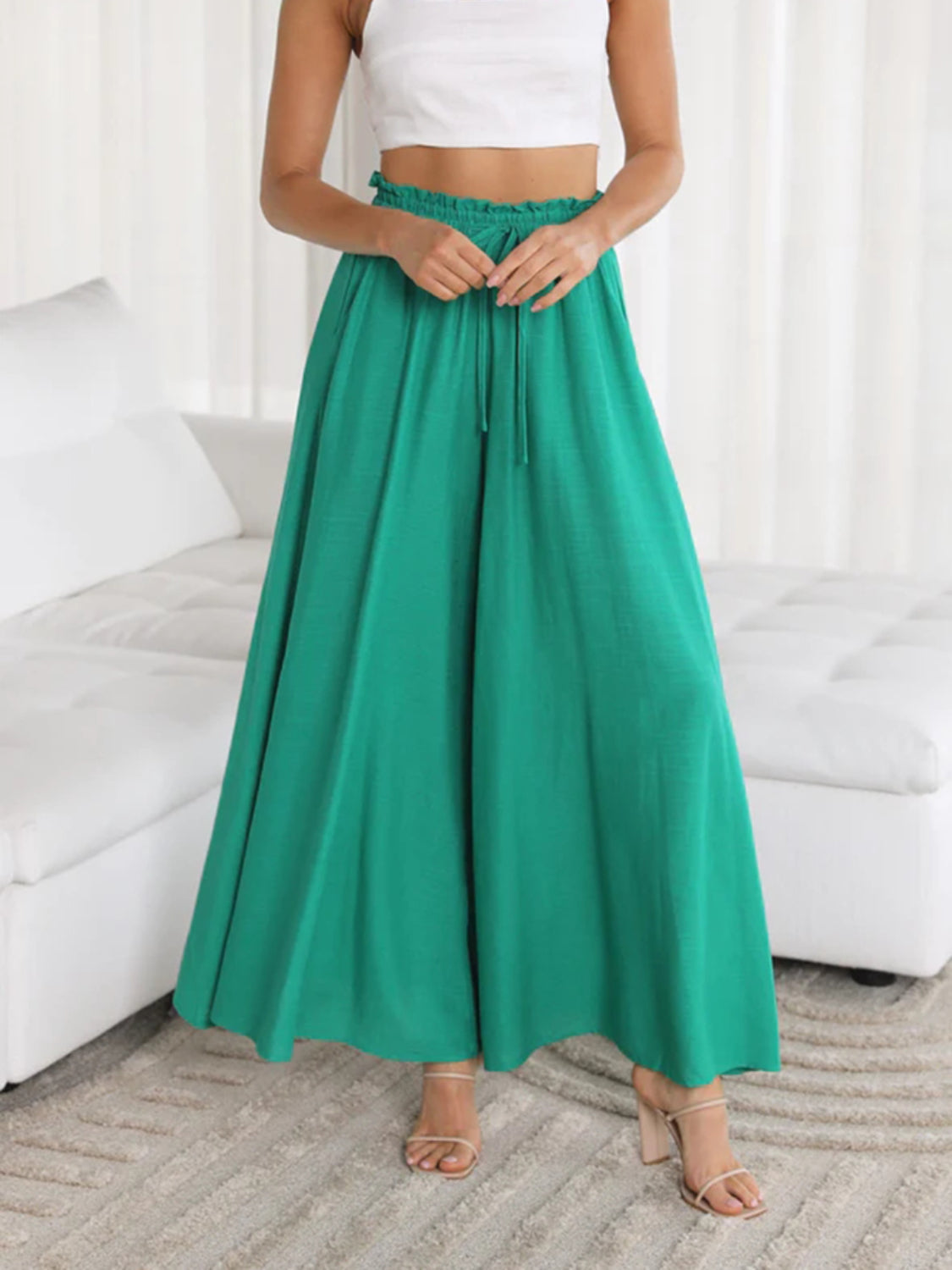 Textured drawstring palazzo trousers in turquoise with a wide leg and flowy silhouette.