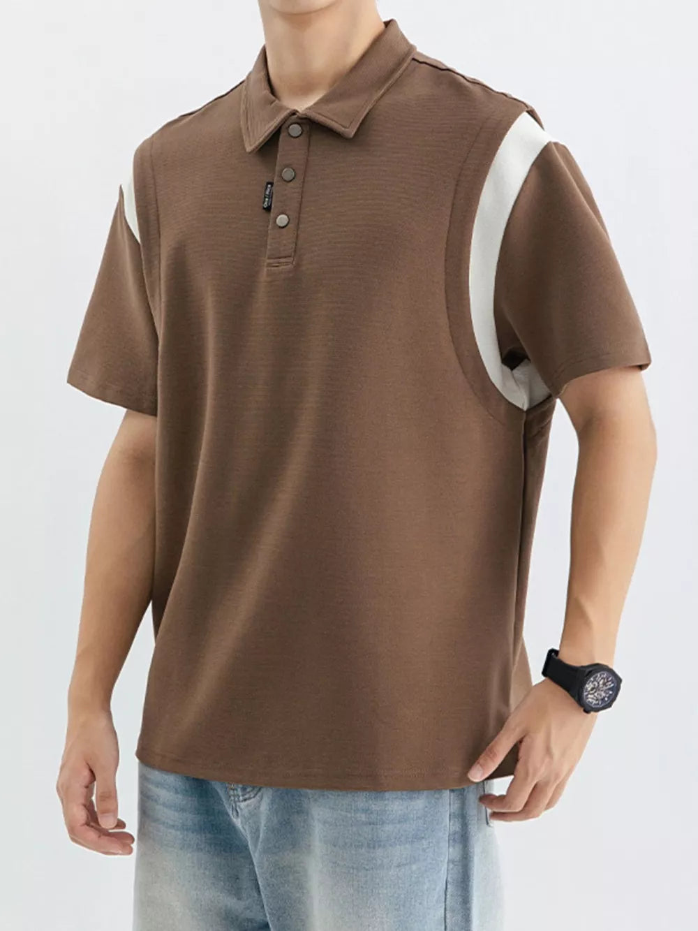 Brown cotton polo shirt with white contrast shoulder panels and buttoned placket.