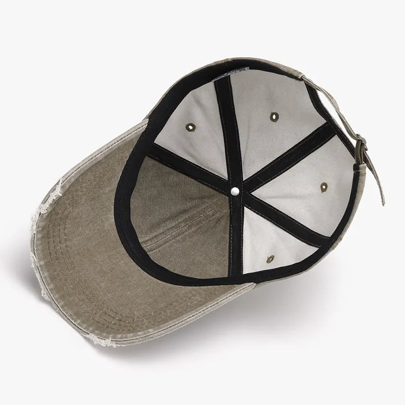 Faded denim baseball cap in Moss with distressed brim and adjustable strap.