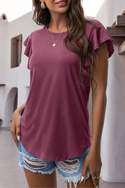 Burgundy t-shirt with ruffled short sleeves and a crew neck, styled with ripped denim shorts.