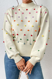 Cream blouson sweater with multicolor pom-pom embellishments and mock neck