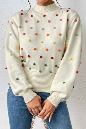 Cream blouson sweater with multicolor pom-pom embellishments and mock neck