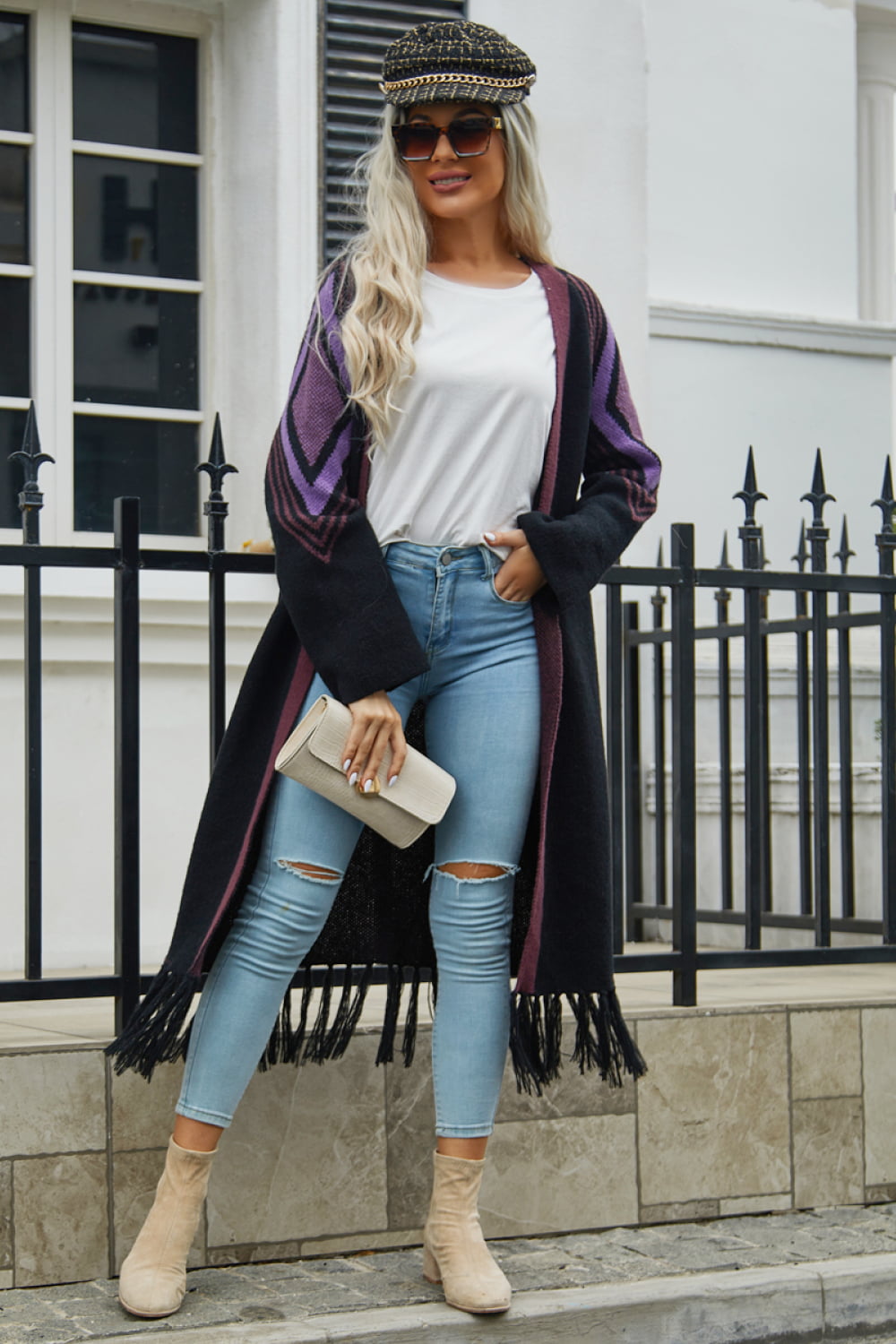Long black cardigan with geometric purple trim and fringed hemline.