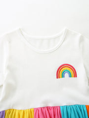 White cotton toddler dress with embroidered rainbow and colorful tiered skirt.