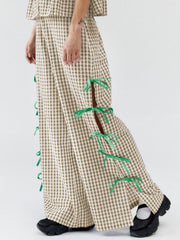 Gingham wide-leg trousers in tan with green bow details on side slits.