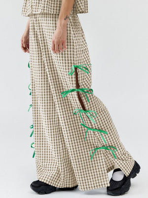 Gingham wide-leg trousers in tan with green bow details on side slits.