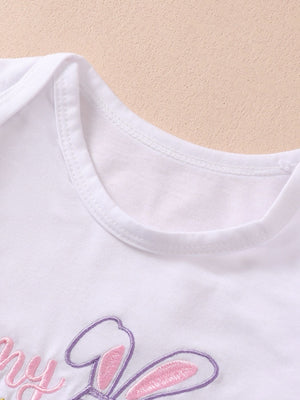 White cotton baby bodysuit with pink and purple bunny embroidery and text.