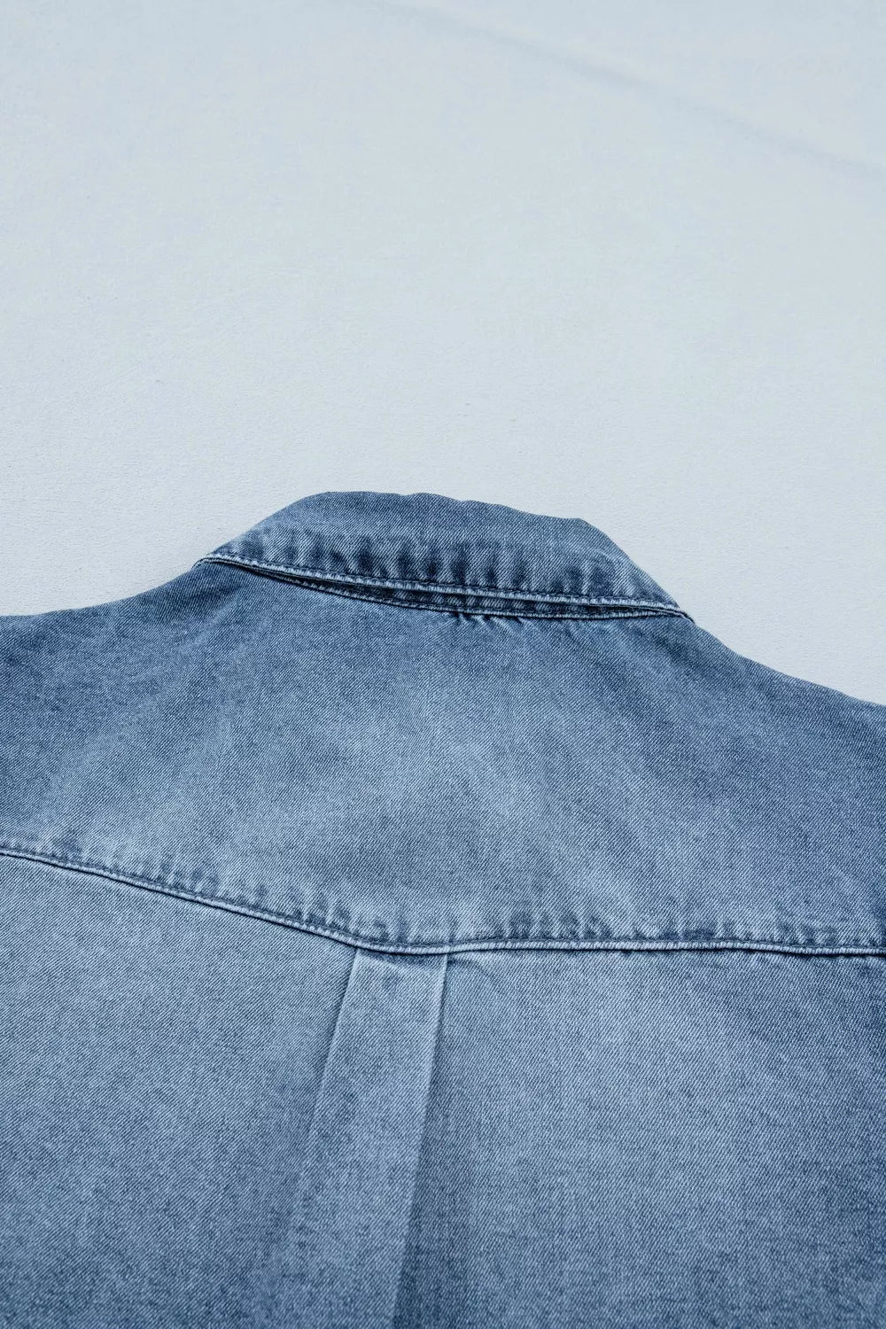 Denim shirt with collar detail and pleat on back yoke.