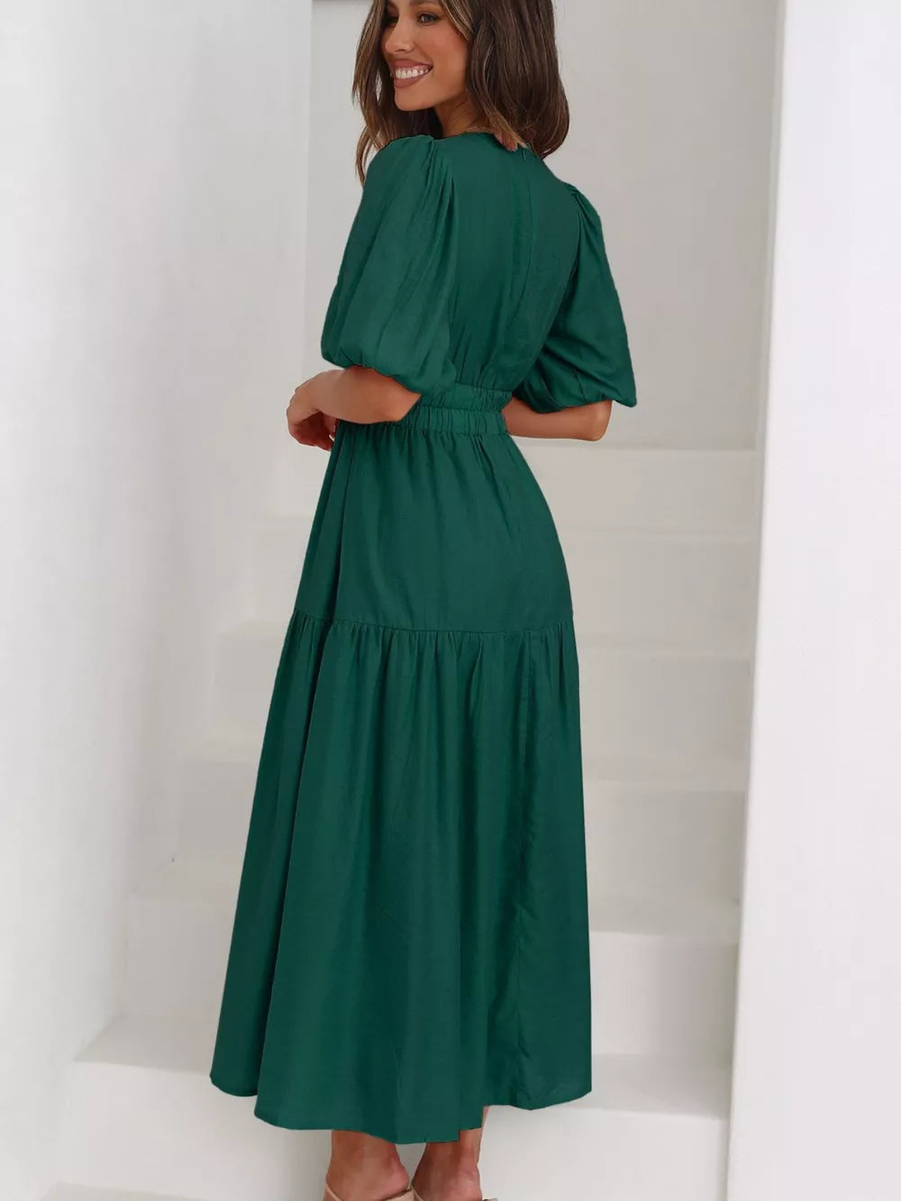 Green midi dress with puff sleeves, cinched waist, and tiered skirt.