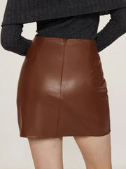 Brown faux leather mini skirt with asymmetric hem and back zipper detail.