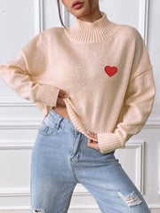 Apricot cropped turtleneck knit sweater with embroidered red heart detail