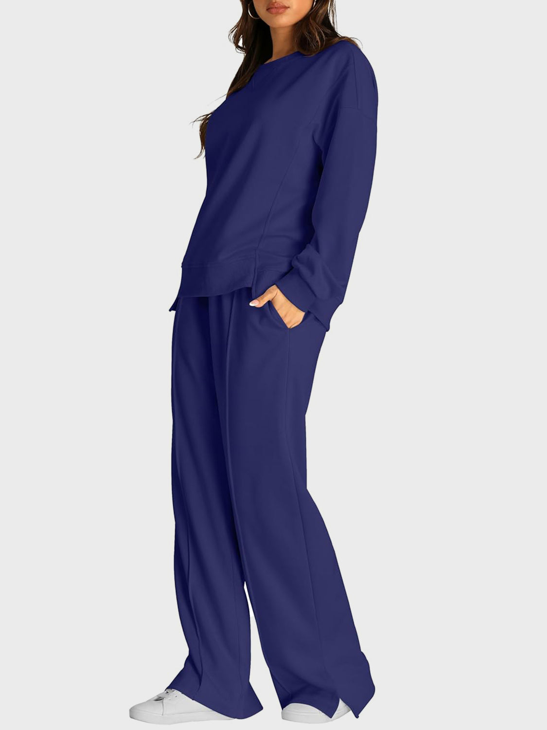 Dark blue seamed loungewear set with crewneck sweatshirt and slit-front wide-leg trousers.