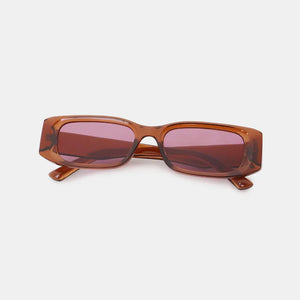 Chunky rectangular sunglasses in caramel with pink lenses.