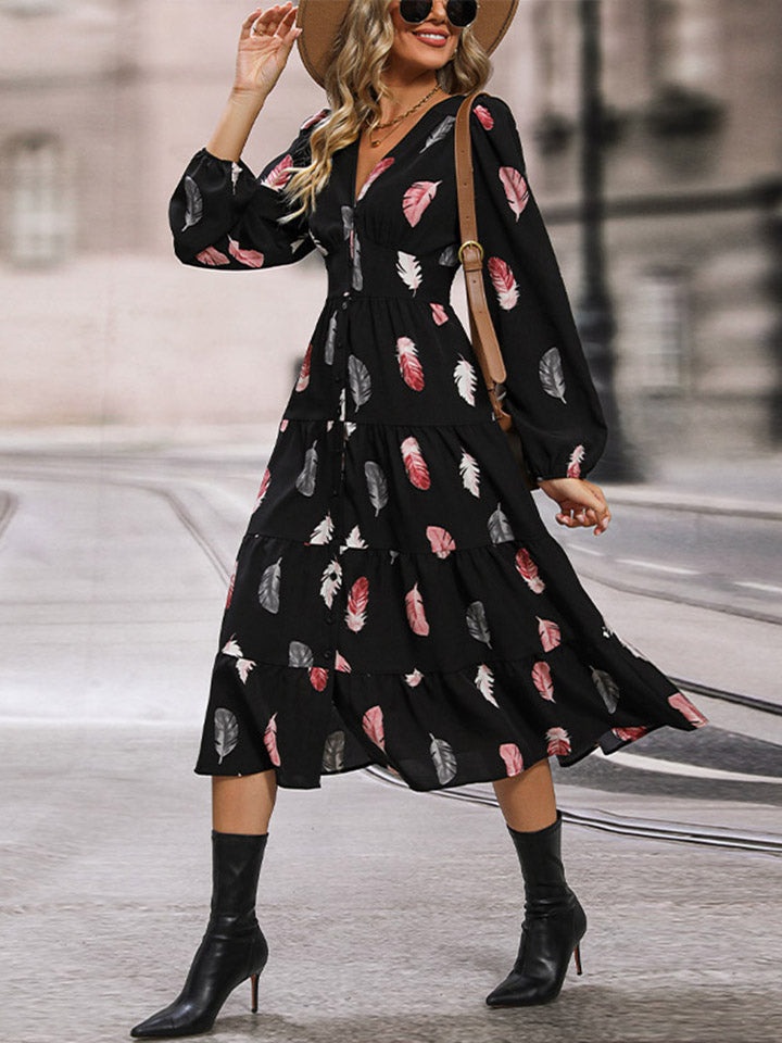Black tiered midi dress with feather print, V-neck, and long sleeves.