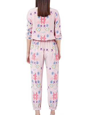 Women's blush pink abstract print loungewear set with crew neck top and pants.