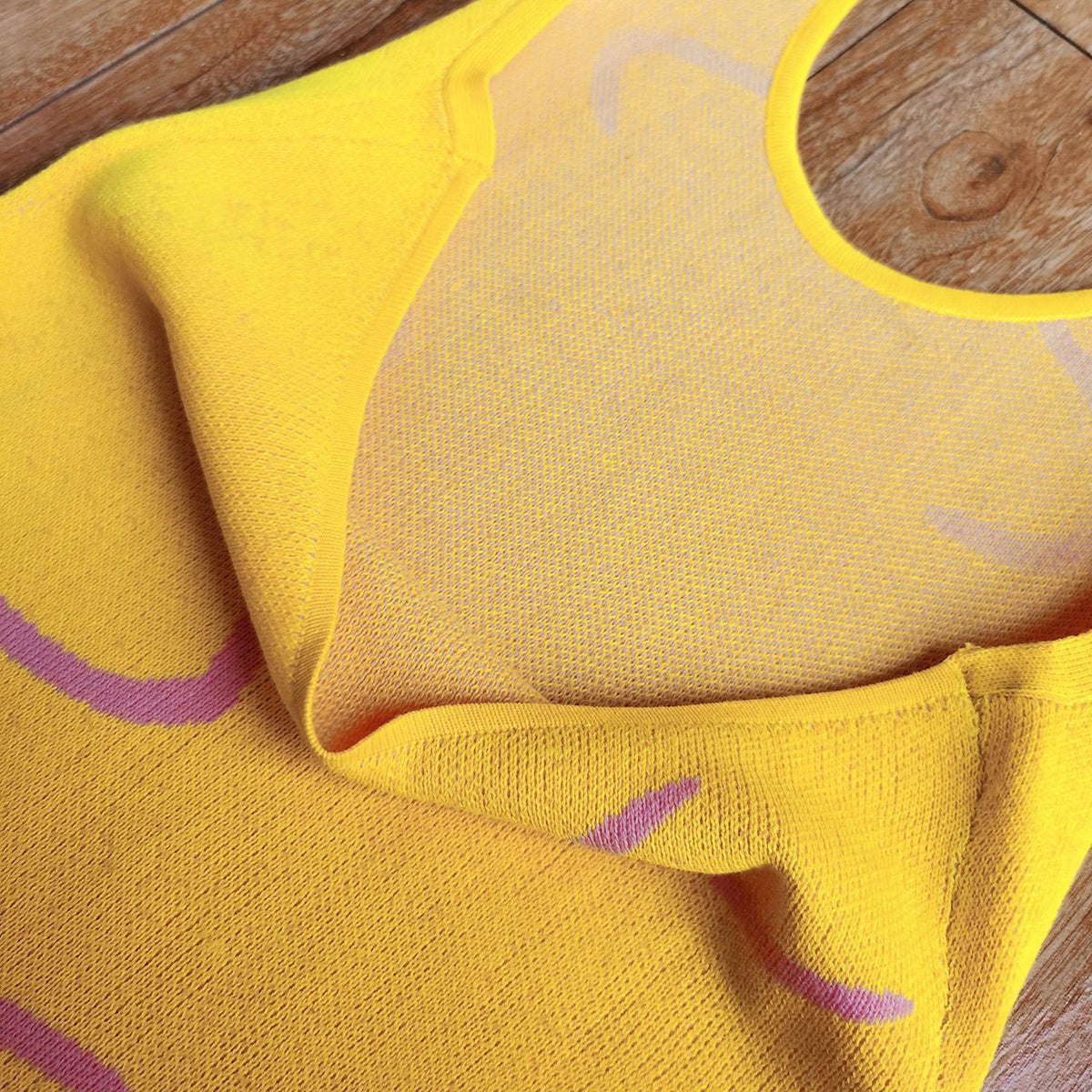 Banana yellow knit halter dress with swirl print detail and mesh lining.