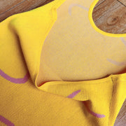 Banana yellow knit halter dress with swirl print detail and mesh lining.