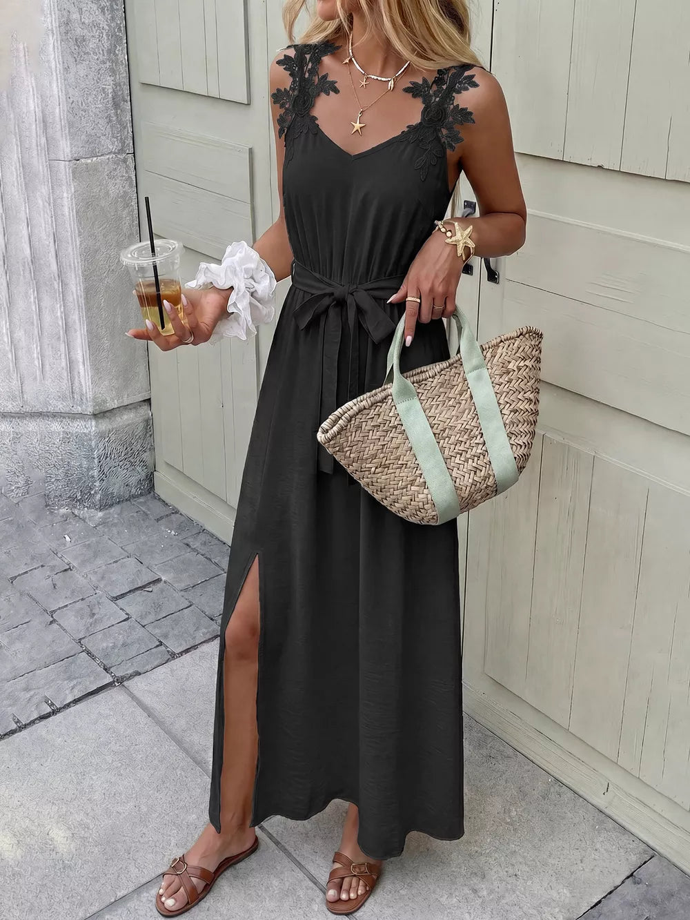 Black lace-trimmed maxi dress with V-neck, tie waist, and high slit.