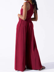 Burgundy square neck palazzo jumpsuit with wide legs and pleats.