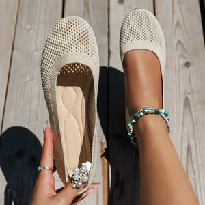 Beige breathable knit ballet flats with pearl embellishment and beaded anklet.