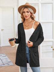Black textured ribbed knit button-down cardigan with pockets and a relaxed fit.