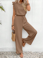 Taupe textured ruffle sleeve drawstring jumpsuit with wide leg pants.