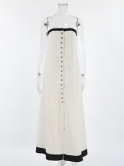 Button front tube maxi dress in beige cotton blend with black trim and button detail.