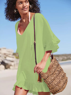 Light green ruffled V-neck beach cover-up with flutter sleeves and hem.