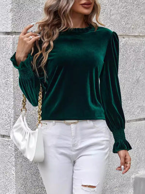 Dark green velvet blouse with ruffled neckline and blouson sleeves.