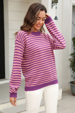 Mauve and purple striped knit crewneck sweater with long sleeves.